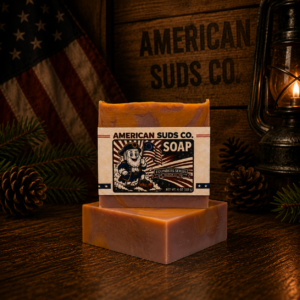 American Suds Co. handcrafted cold processed soap bar with swirly flat top, orange and rose clay colored swirl, a sweet crisp apple, peach and jasmine scent with very light jojoba bead grit.